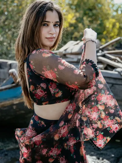 A full-body shot of the floral lehenga. The pose is graceful and shows off the flow and print of the outfit beautifully.