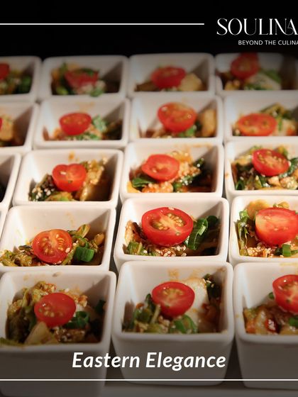 Eastern elegance captured in a bite. These small bowls contain a vibrant Asian-inspired salad, topped with a cherry tomato for a pop of colour and freshness.