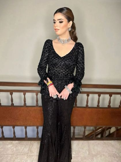 This pose shows how a high ponytail can create a very strong and confident profile, perfect for a modern event look.