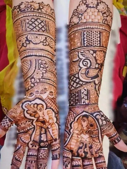 A beautiful example of combining couple portraits with traditional art. The palms feature the bride and groom, while the arms are decorated with intricate patterns and peacock figures.