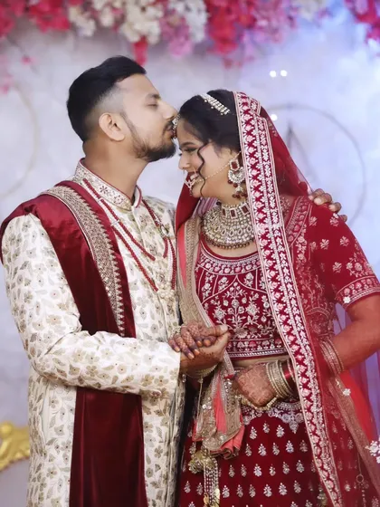 A tender moment between the newlyweds. The bride's glamorous makeup, with a bold lip and defined eyes, is perfect for her reception.
