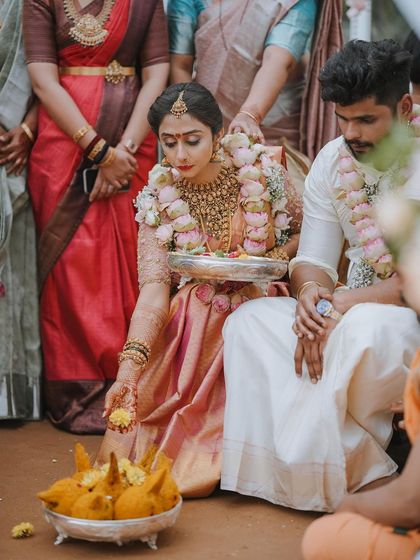 The bride performs a ritual at the mandap, her focus and devotion beautifully captured.
