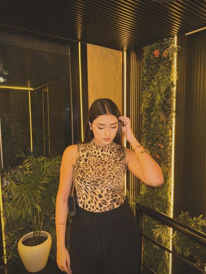A candid shot of the leopard print outfit, looking down.