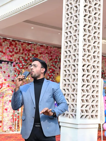 A candid shot of me performing with a flaming wallet at an outdoor event. The element of danger adds to the excitement of a live show.