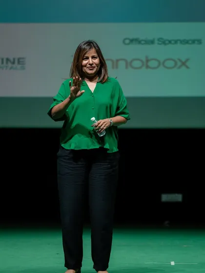 A candid moment during my keynote address. My goal is to connect with the audience on a personal level, sharing stories that are both inspiring and relatable for a corporate setting.