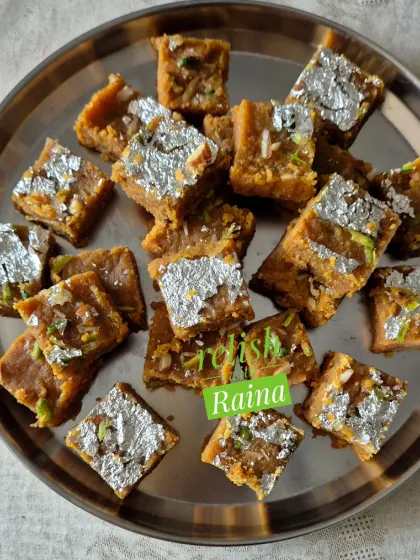 My Moong Daal Barfi, decorated with pure silver vark, is a festive favorite. I roast the lentils for hours in pure ghee to achieve that perfect golden color and rich, melt-in-your-mouth texture.
