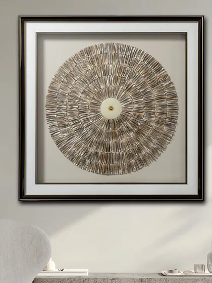 The Echoes of Orbit shadow box is a stunning decorative piece for contemporary spaces. The circular design is created with textured, layered elements that draw the eye to the center, creating a focal point.