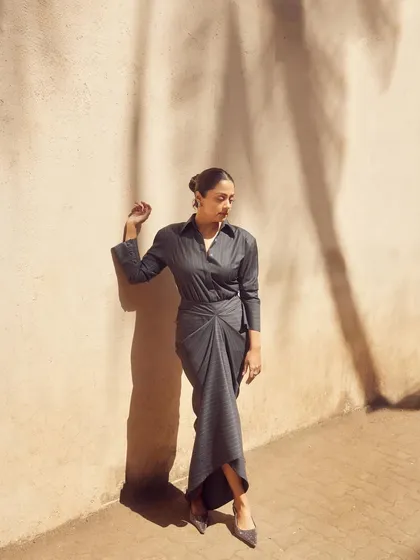 The sunlight creates beautiful shadows, adding an artistic touch to this shot of the pinstripe dress.