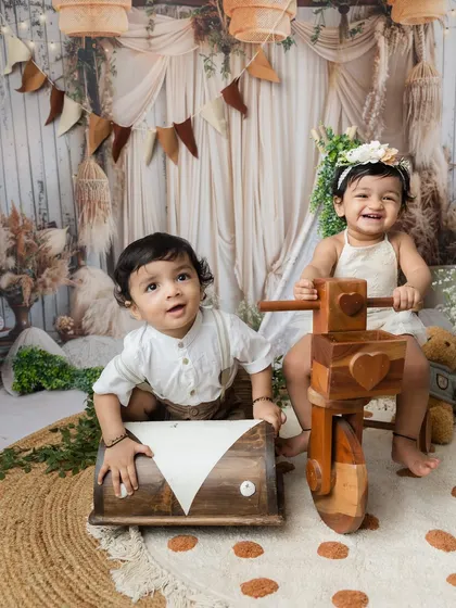 A playful moment between siblings. The big sister's laugh is infectious!