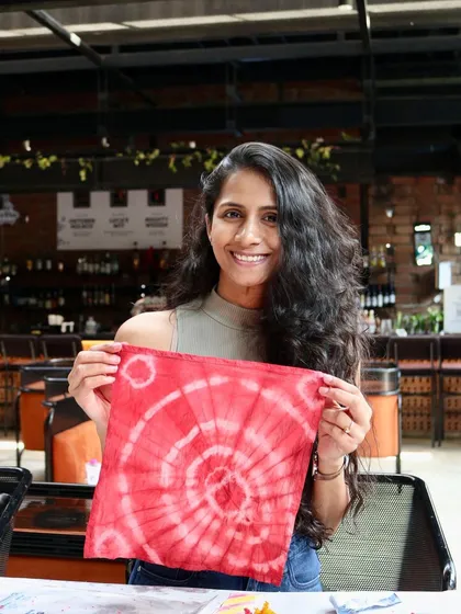 A stunning circular pattern on a red napkin, created at our 'Sundye' party. It's always a joy to see the beautiful and unique designs that emerge from the dye bath.