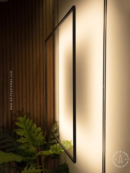 A close-up of the suspended frame light, showing its slim profile and the soft diffusion of the light source.