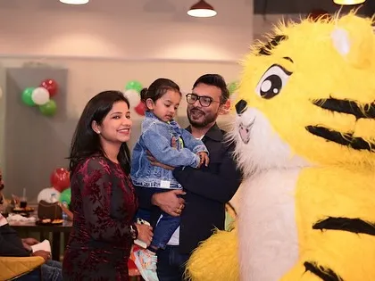 A mascot tiger greeting a young guest. These character appearances are always a huge hit and create wonderful, interactive memories.