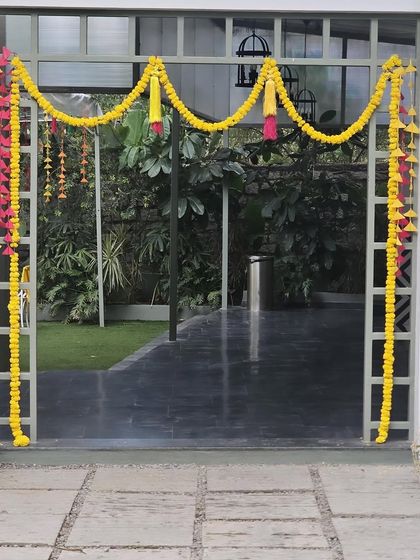 Another angle of the simple and elegant marigold entrance arch, perfect for adding a traditional touch to any home celebration.