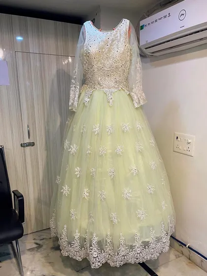 A clear, full shot of the lime green ballgown, showing its flattering A-line shape and intricate detailing. It's an ideal rental for a fairytale moment.