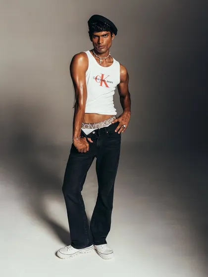 This shot captures the full silhouette of the styled look for Calvin Klein. The pose is dynamic, conveying a sense of confidence and effortless style that is central to the brand's identity.