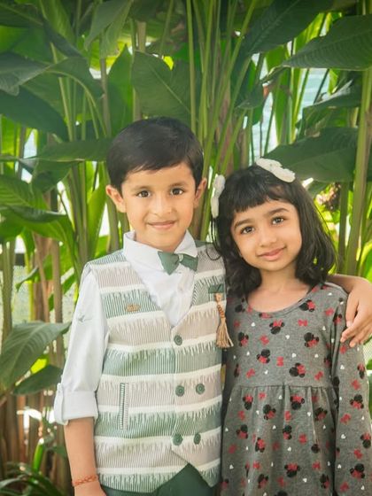 A brother and sister pose together during a birthday party. Even amidst the fun and games, we can capture a beautiful, classic portrait.