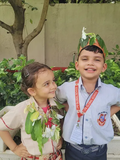 A beautiful moment of friendship and shared love for nature as two students display their green ornaments during Van Mahotsav.