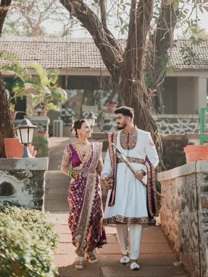 The couple walking hand-in-hand, looking like royalty in their coordinated traditional outfits. This shows my ability to style both bride and groom.