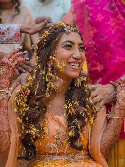 Haldi and mehendi, a perfect combination. A candid moment of pure joy as my bride Akshata is showered with flower petals during her haldi ceremony.
