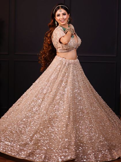 A fun, twirling shot of the bride, showing the beautiful flare of her lehenga.