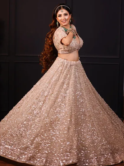 A fun, twirling shot of the bride, showing the beautiful flare of her lehenga.