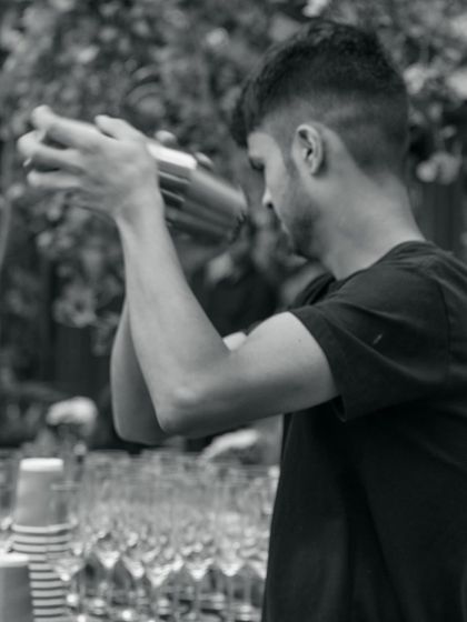 Our mixologist shaking up cocktails for a private event. The beverage experience is curated with the same care as the food.