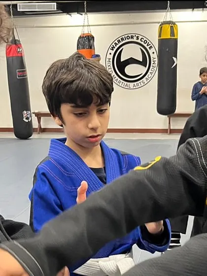 Students practice techniques on each other, learning through doing. This partner drill focuses on grip fighting, a fundamental skill in Jiu-Jitsu for controlling an opponent.