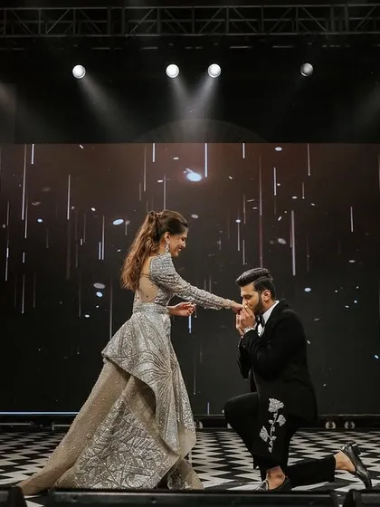 A romantic moment on stage between the couple. The checkered dance floor and the starlit background on the LED screen created a classic, glamorous setting.