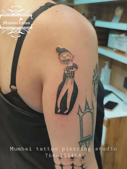 A unique tarot card tattoo on the upper arm. We enjoy bringing mystical and symbolic art to life, ensuring each detail from the original card is captured.