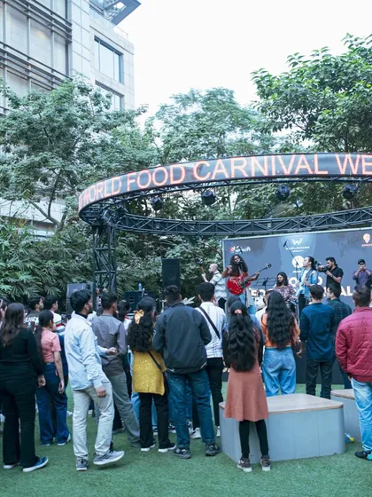 A wide shot of the audience enjoying a live band at the World Food Carnival. It shows how our events bring people together to share in music and celebration.