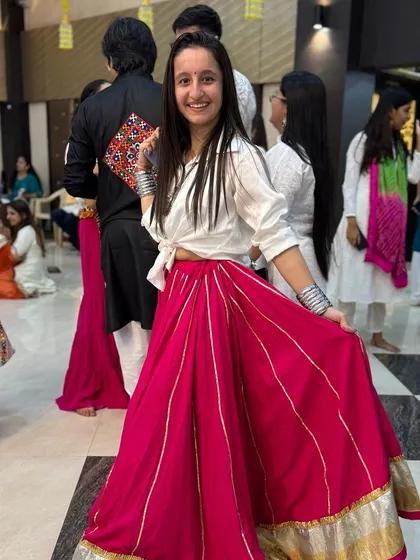 My look for Day 1 of a Navratri event, pairing a modern white shirt with a traditional pink skirt. I love mixing and matching to create unique desi looks.