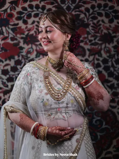 Another angle of our minimalist bride, Pooja, showing her complete look. The white and gold lehenga paired with soft makeup creates a sophisticated and modern bridal style.