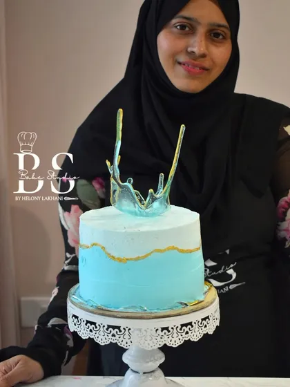 This student's creation features a cool blue ombre effect on whipped cream, topped with a striking blue and gold isomalt crown.