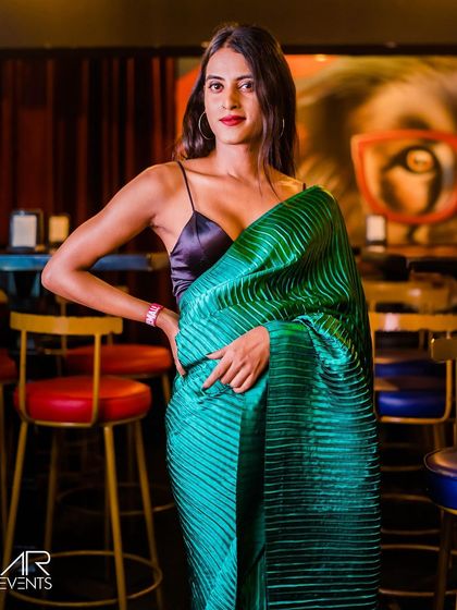 A guest in a stunning green saree, bringing elegance to the club.