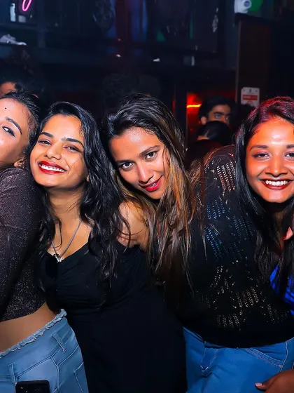 A group of friends smiling and laughing together.