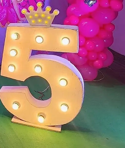 A light-up marquee number '5' with a crown, adding a royal touch to the butterfly fairy birthday party.