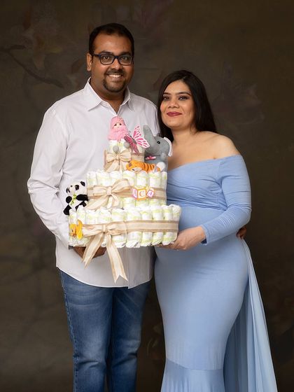 A fun and creative shot with a diaper cake, celebrating the practical and exciting preparations for the baby's arrival.