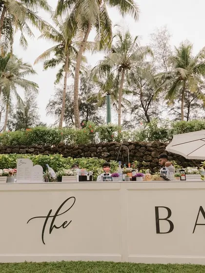 A chic, modern white bar setup for a beachside event in Goa, ready to serve guests as they enjoy the sunset.