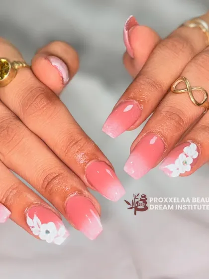 Another angle of the pink and white ombre nails, highlighting the delicate, multi-layered petals of the 3D sculpted flowers. This is a perfect look for a special occasion.