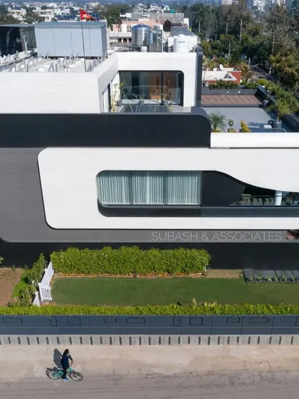 An aerial view of Residence 100 in Panchkula, showcasing its unique oblong facade that makes a bold architectural statement.