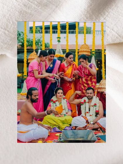 A fun, candid moment during the ceremony where the groom playfully shows off his strength.