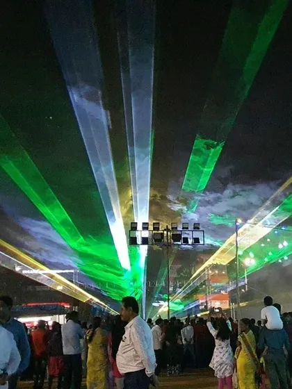 Here is an example of our work at a large public festival. We projected wide sheets of green and white laser light over the crowd, creating a ceiling of light that enhanced the event's atmosphere and provided a memorable visual experience for all attendees.
