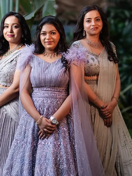I love creating a cohesive story for the entire family. Here, three sisters celebrate a special occasion in coordinated custom lehengas and gowns in shades of lavender and silver, each with unique details reflecting their individual style.