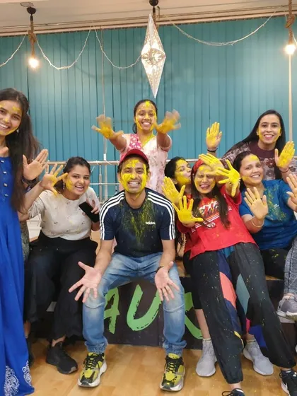 We are the Aura Family, and this is how we celebrate. This moment from our studio's Holi party captures the joy and community spirit that you'll find in our classes every single day.