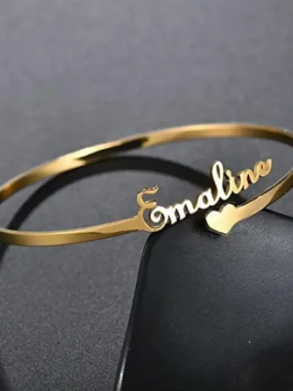 Simple, elegant, and personal. Our custom name bracelets are a classic for a reason. This piece features a delicate script name on a polished gold-finish bangle, making it a perfect everyday accessory or a heartfelt gift.