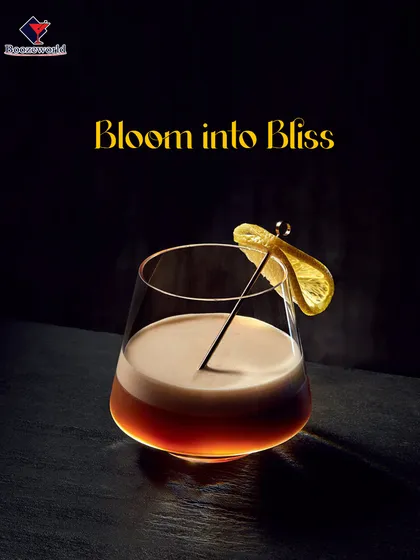 A dark and moody cocktail with a creamy foam top, garnished with a dehydrated lemon wheel. This drink offers a blissful, indulgent experience for those who appreciate deeper, more complex flavors.