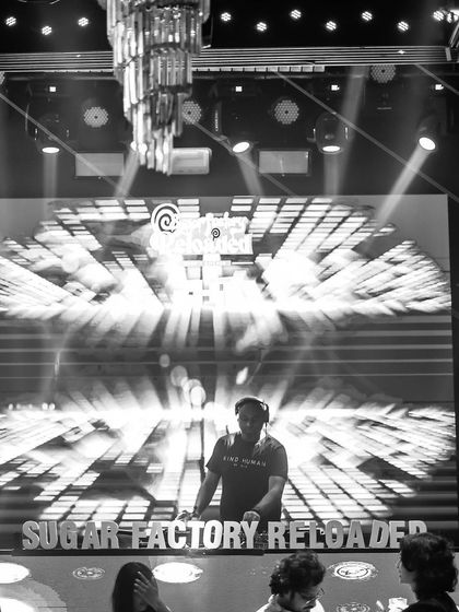 A black and white shot of me at the console, capturing the intensity and focus of a live set.