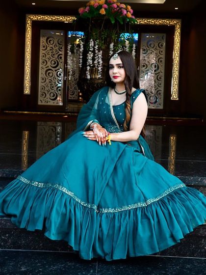 A beautiful teal gown with a ruffled bottom. This is a simple yet elegant rental piece for a guest who wants to look stylish and sophisticated.