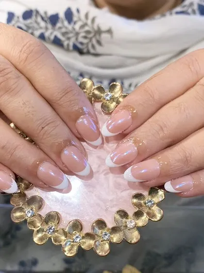 A timeless, clean, and perfectly executed classic French manicure on elegant almond-shaped nails.