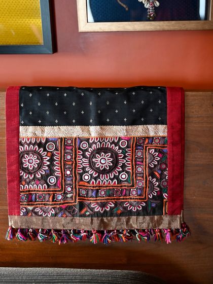 The runner folded to show both the intricate embroidery and the simple elegance of the polka-dot silk. This piece is perfect for adding a touch of handcrafted luxury to a bed or table.